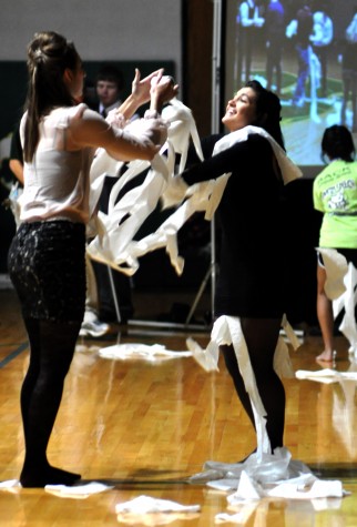 Mariah Simmons, sr., and Courtney Kalb, sr., vigorously unroll toilet paper in the captains games.