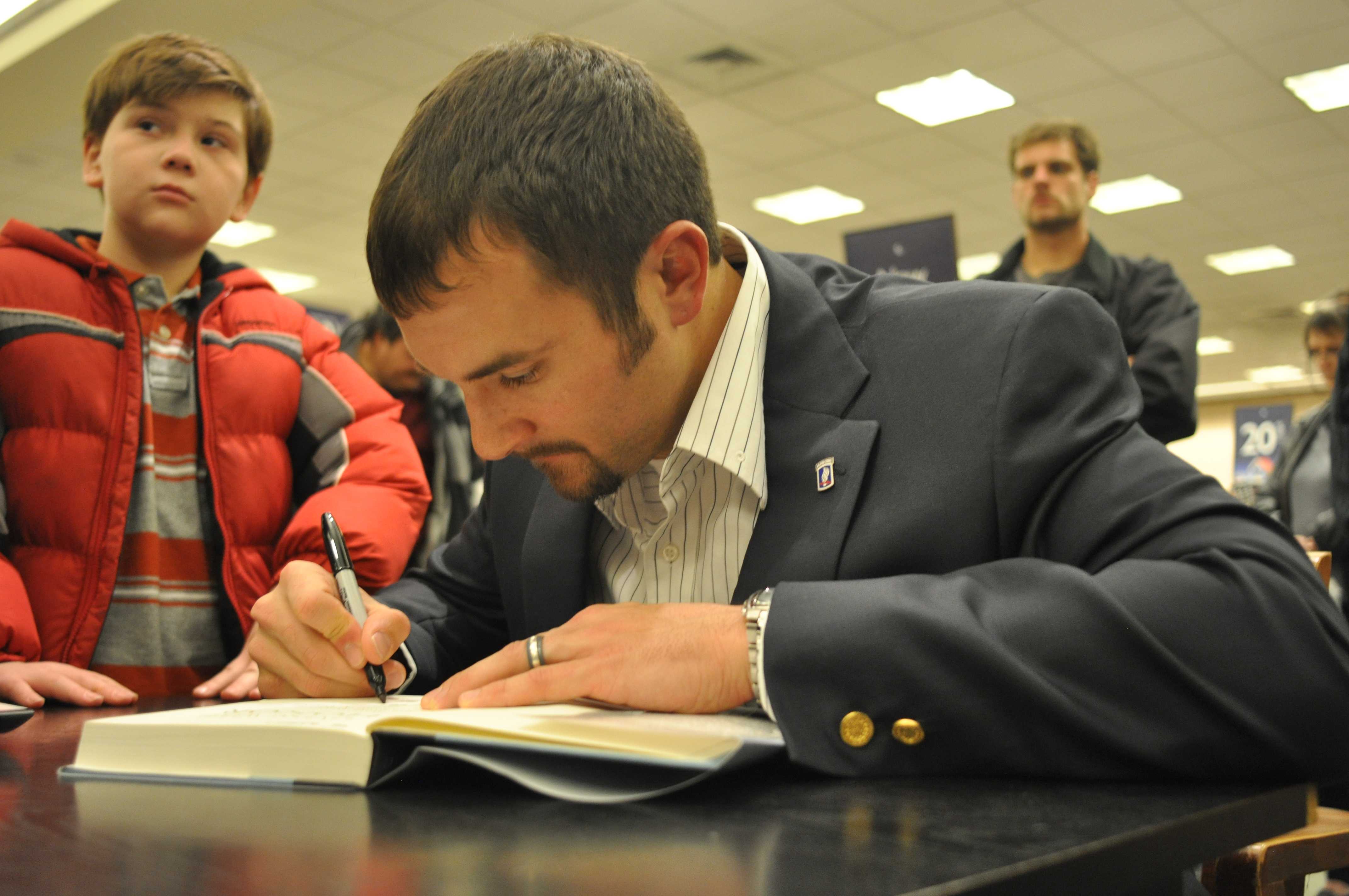 Sal Giunta signs copies of his books to those who came out to Barnes & Nobles to hear him speak. 