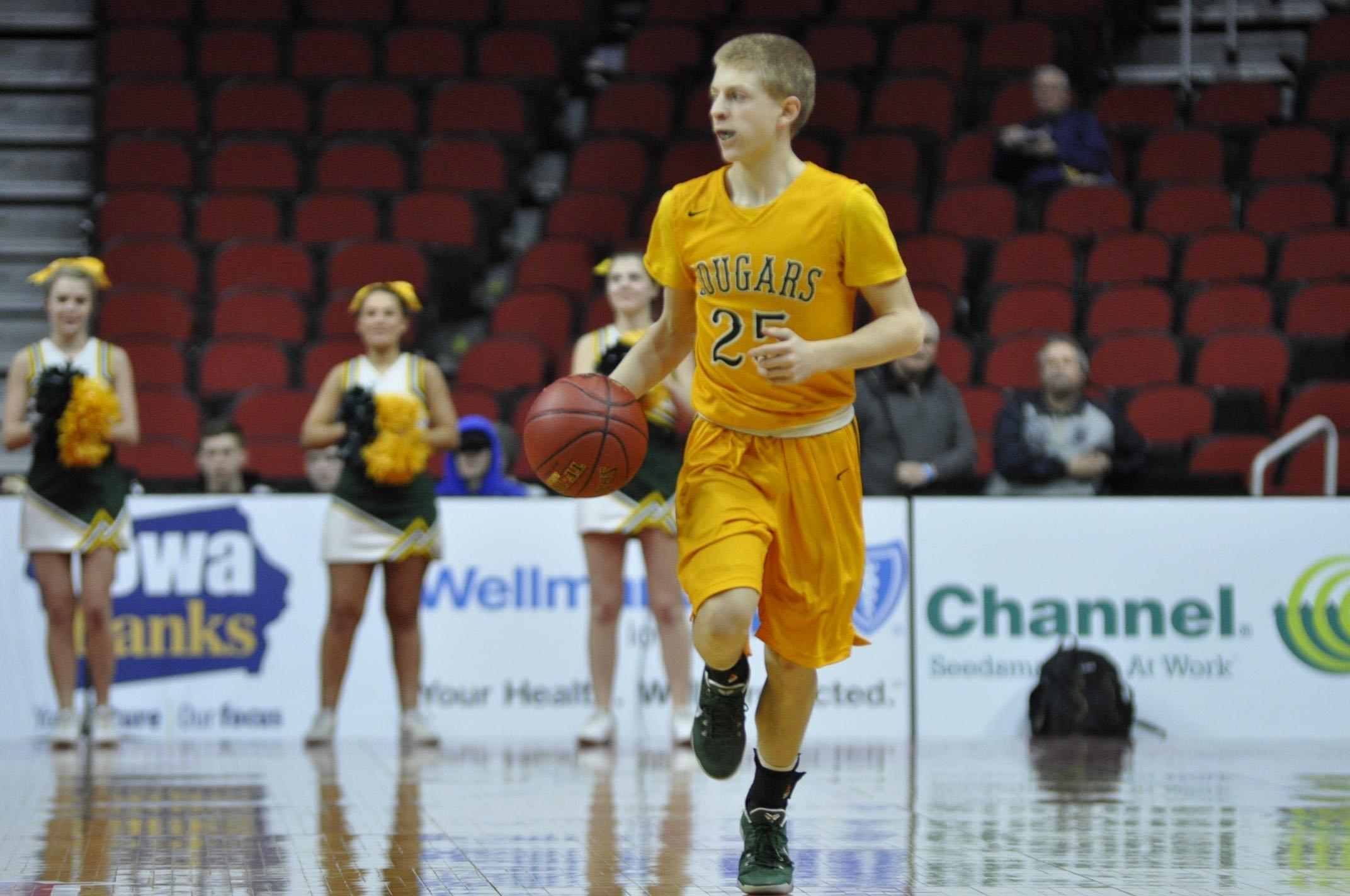 Jackson foley (25) dribbles up the court during the first game of the state tournament. Foley finished the game with 14 points. Photo by Nathan Sheeley.