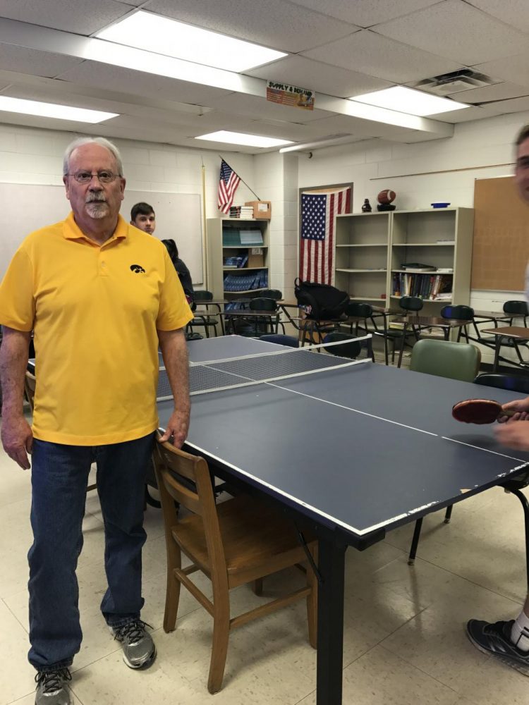 Pat Grady hanging out during Smart Time while students play ping pong in his room. Photo by Anna Reinhart.