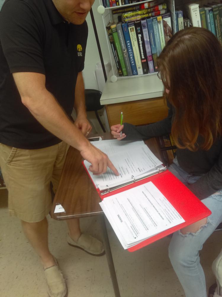 Teacher Bob Young works with Aleigha Thompson, fr., on the Earth Science final review packet. Finals are Thursday and Friday for Kennedy students.