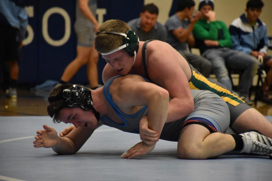 Cael Knox uses an under arm move to try top keep his opponent from escaping. Knox ended the match with a pin in the third round. Picture by Camber Ostwinkle.