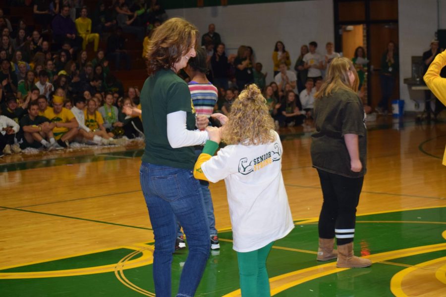 Special Education teacher Mary Gibney and senior Ellie Grovert take center stage with smiles, while Ellie is recognized for being a Special Olympic athlete.  