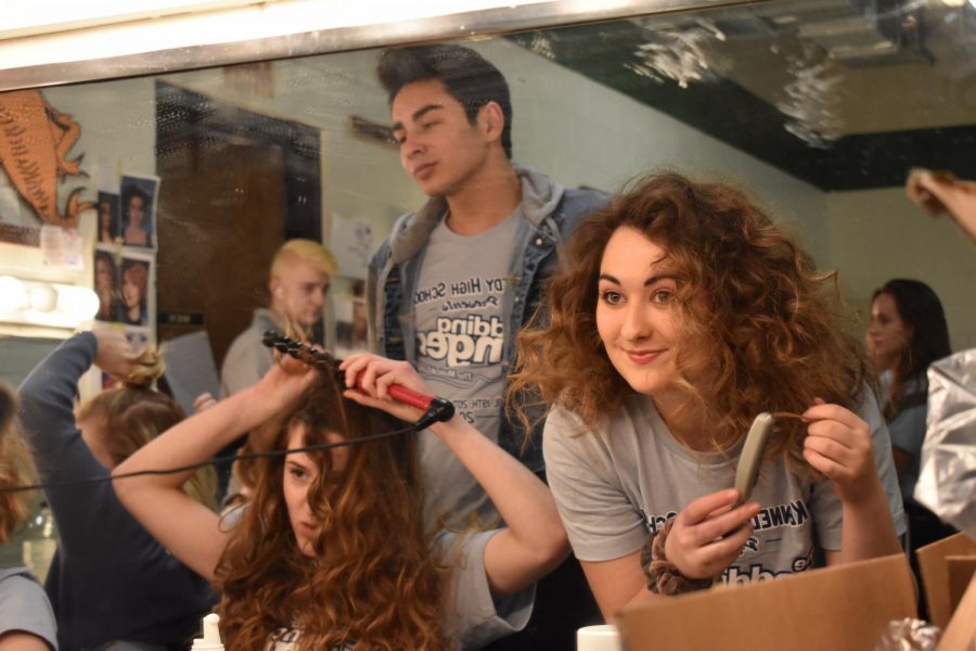 Mallory Nesmith, sr., smiles, enjoying the company of others as they make their final touches before taking the stage for Kennedy's spring musical, The Wedding Singer.