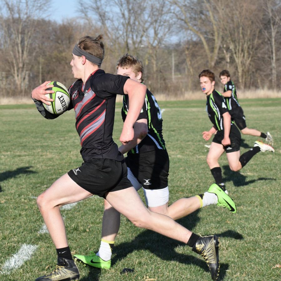 Jake Pearson, sr., outruns three trojans by himself heading for the try zone. 
