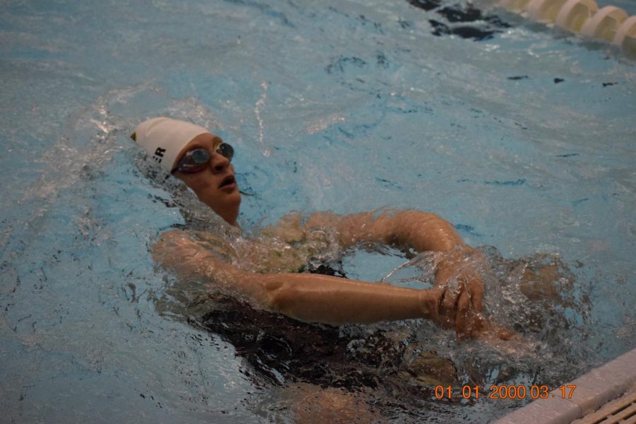 Senior Larin Krautbauer swimming back stroke