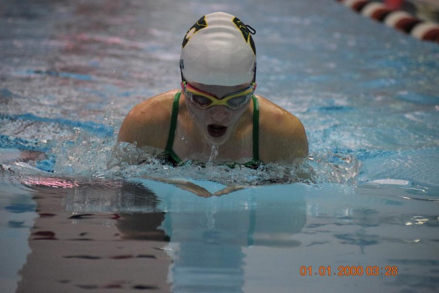 Sophomore Emily Shaw swimming breast stroke.