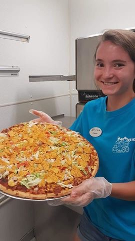 Cassie Lehman sr., making some taco pizza in the snack shack at The Play Station.