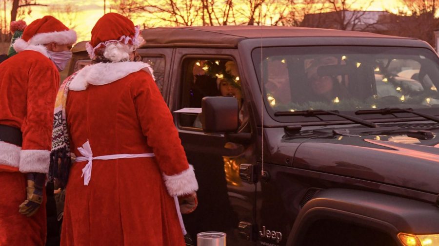 Some students decorated their cars for the drive-thru. Santa and Mrs. Claus approach students in their Jeep adorned with Christmas lights.