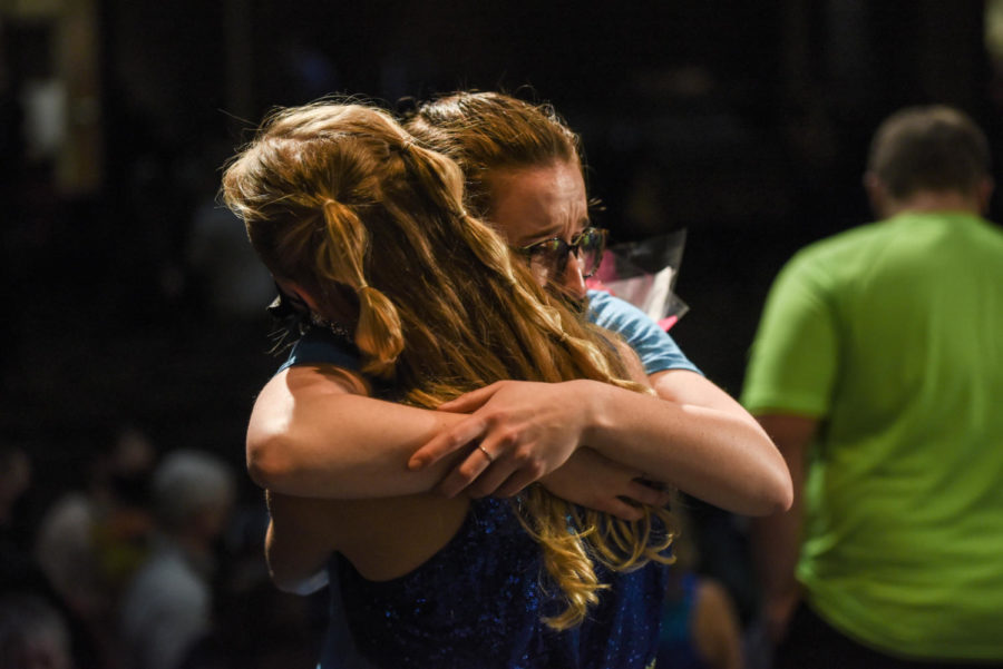 A Happiness performer embraces her relative after the show.