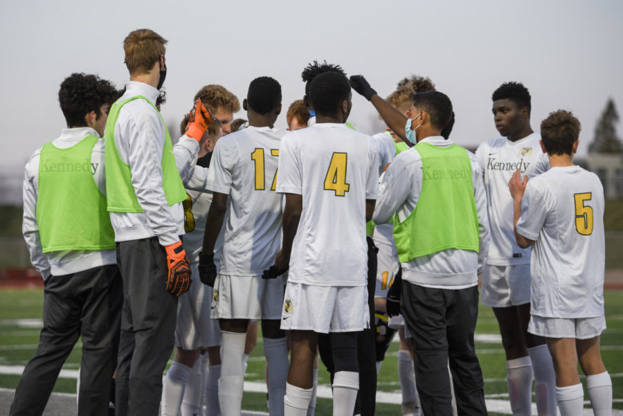 The Kennedy boys soccer team huddles together before the game.