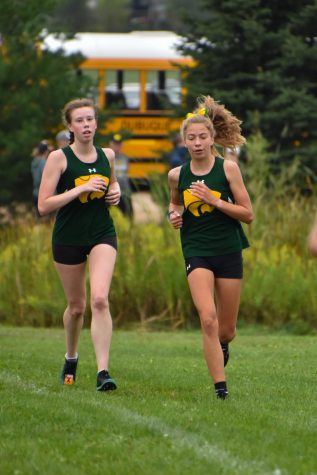 Senior Kayleigh Duncan and sophomore Alyssa Brandt run together for the cross country team at Oakridge.