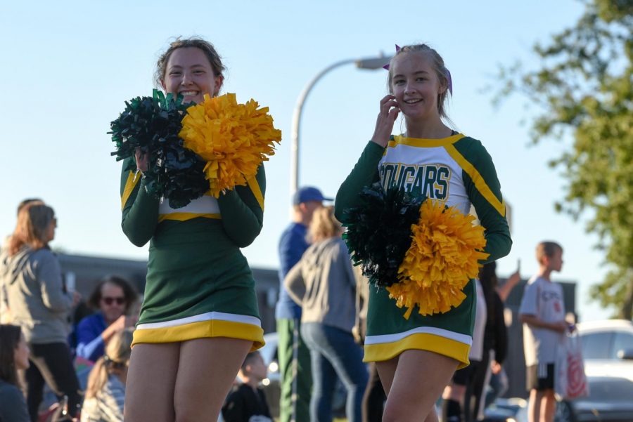Cheerleaders smile at the camera during the 2021 Homecoming Parade.