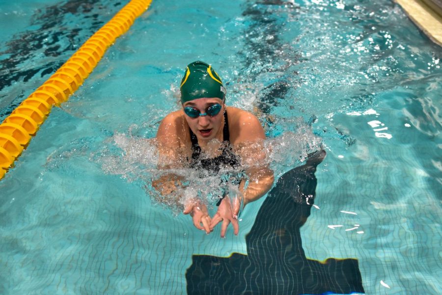 Freshman Lily Adams practices her relay before this weekends meet.