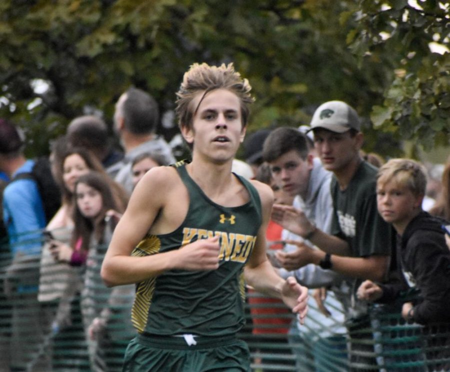 Miles Wilson sprints to the finish line in a cross country race.