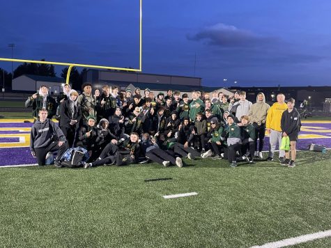 Kennedy Mens Track celebrates their win at Muscatine Invite. 