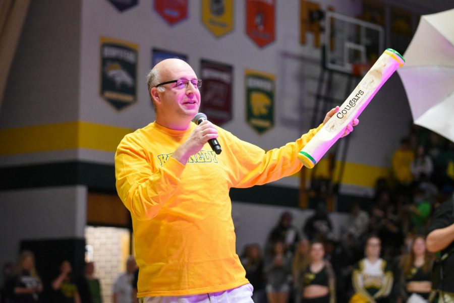 Kline discussing the meaning of the spirit stick at a pep assembly.