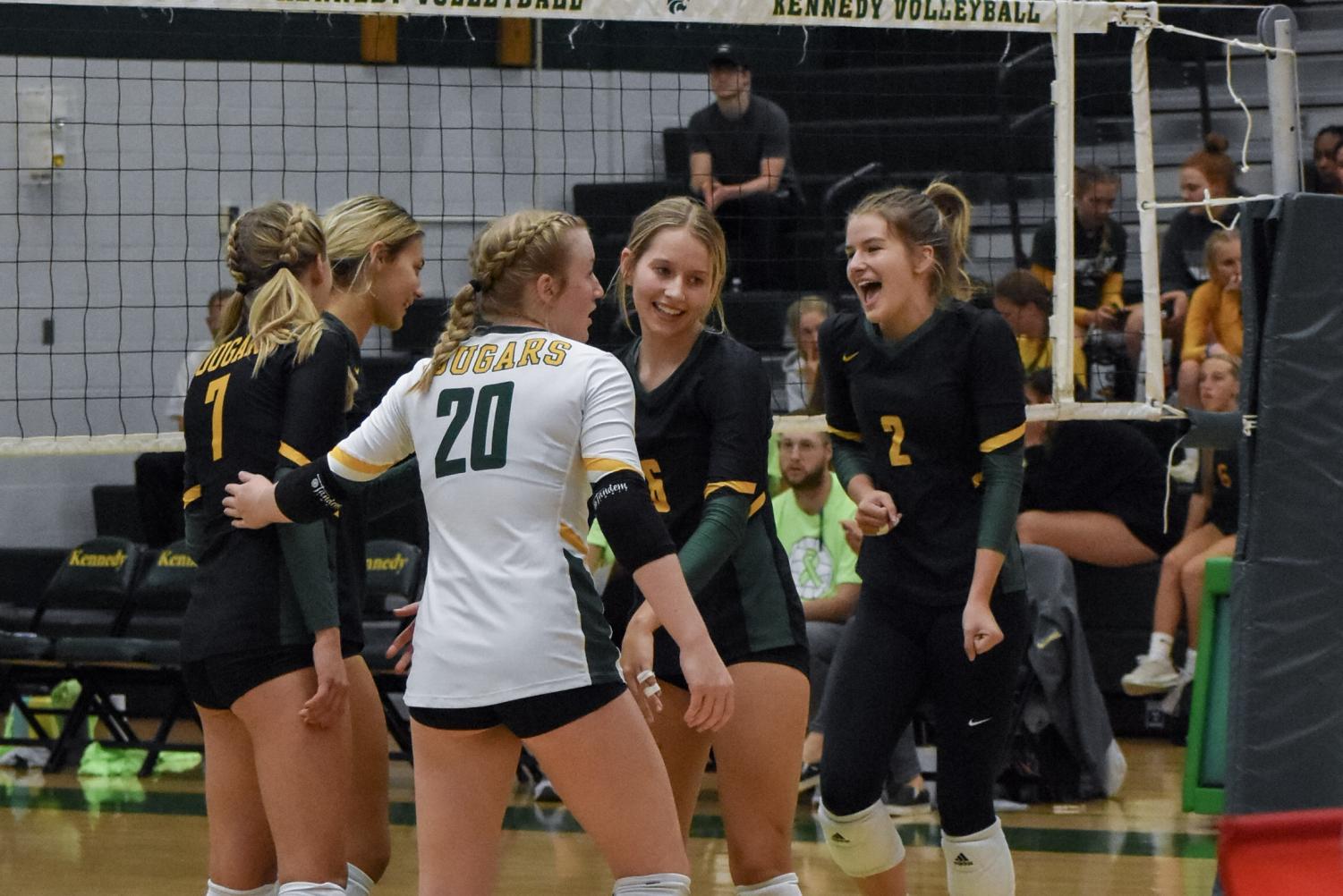 The Kennedy Girls Varsity Volleyball team regrouping during their match.