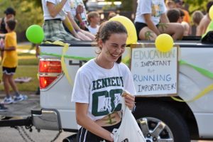 Senior Anabel Bradley throws candy during the 2022 Kennedy Homecoming Parade.