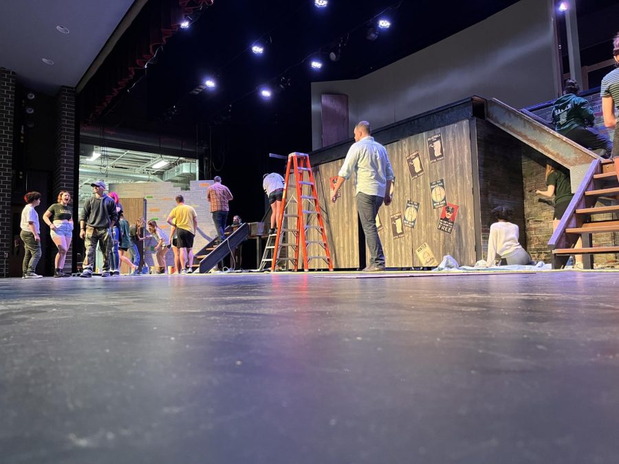 In preparation for the premiere, the Puffs production crew work on the props. The play was moved into the auditorium because of the size of the set.