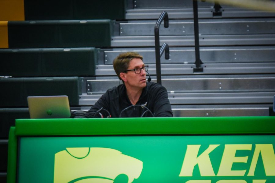 Sports announcer, Glen Wiebel, watches a Kennedy volleyball game. After filling in for Rich Patterson, he fell in love with the job. 