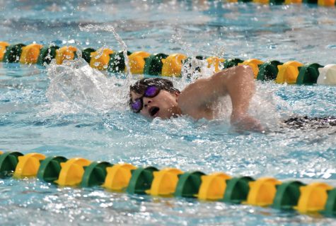 Freshman Sam Bloomquist swims freestyle