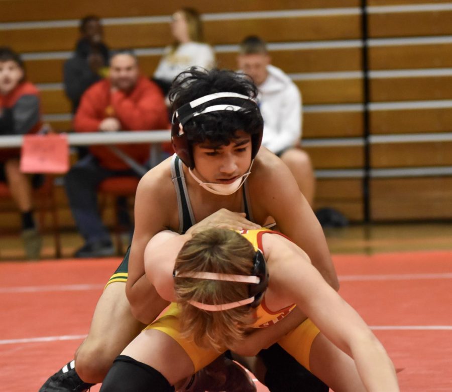 Brent Becerra fighting hard to pin a wrestler from Marion 