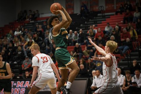 Junior, Cyrus Courtney shooting a mid range jumper.