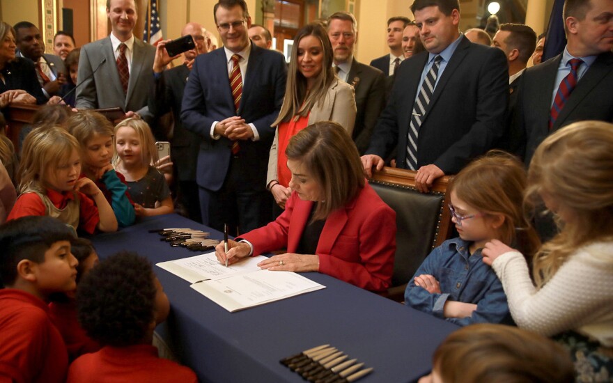 Gov.+Kim+Reynolds+signs+the+Students+First+Act+in+the+Capitol+rotunda.