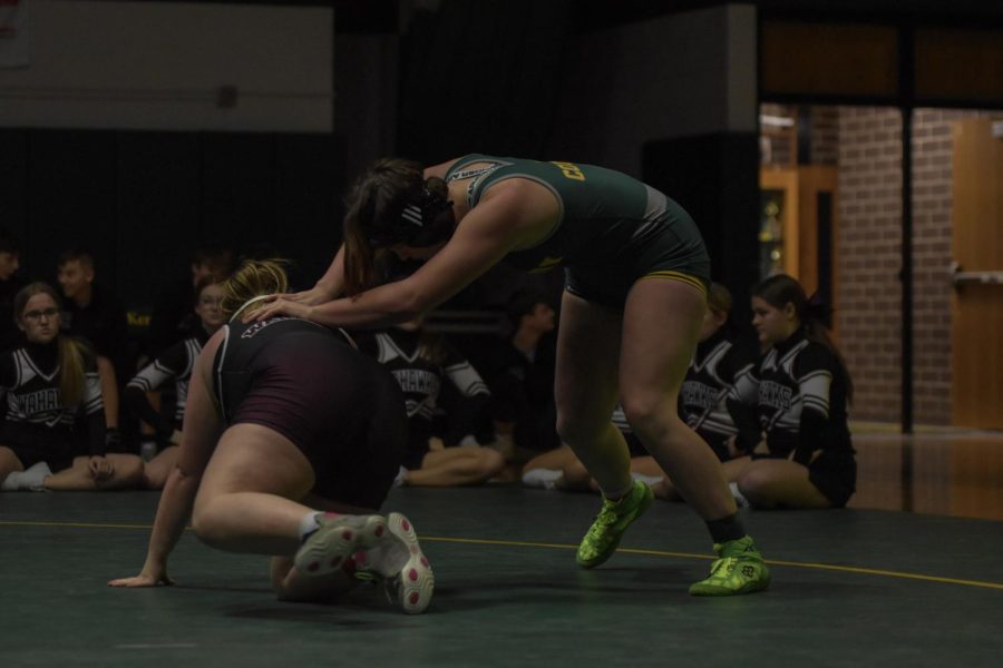 State qualifier Ella Brown wrestles a competitor during a home match. 