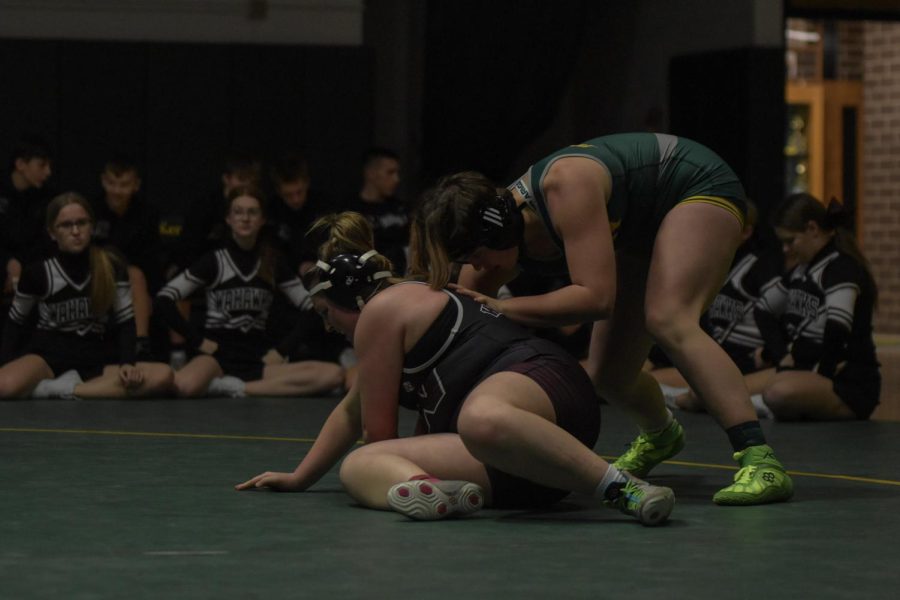 Ella Brown, state competitor, wrestles an opponent during a home meet.