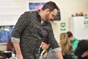 Nick Hayes assists a forensic science student with homework in class.
