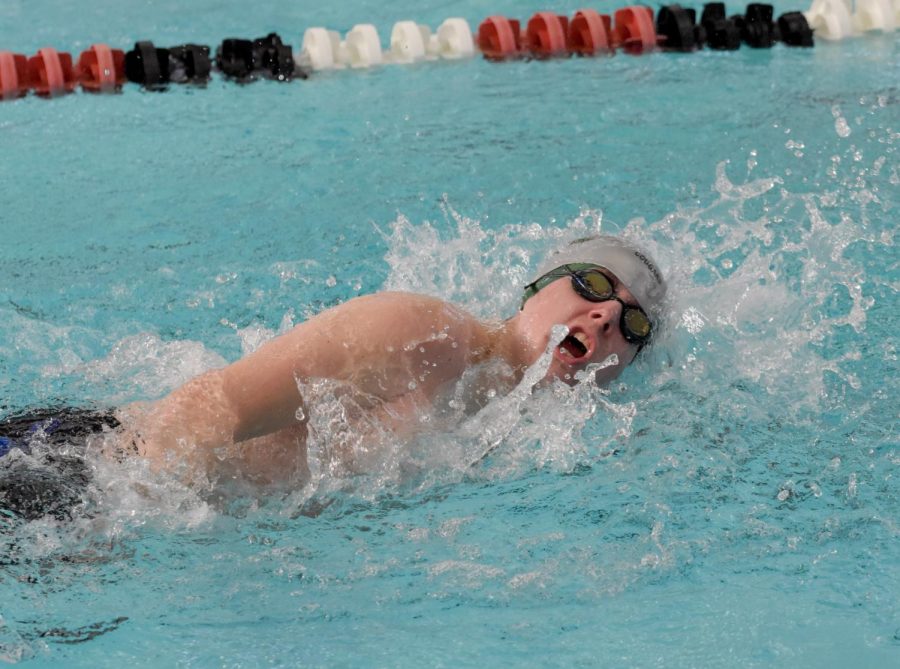 Connor Hageman swims the final lap of the first event of the meet, a relay.