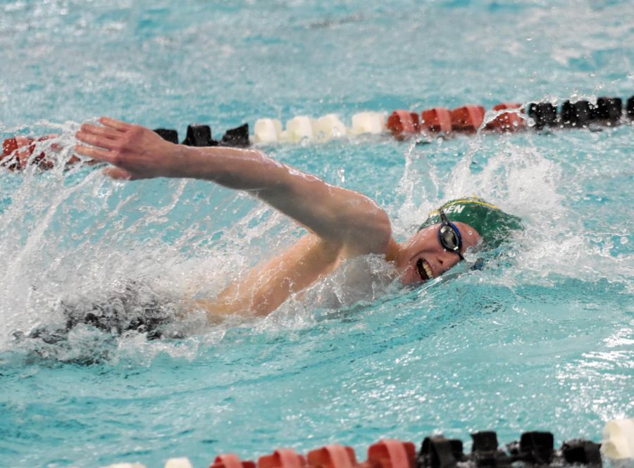 Senior Will Bowden swims the final stretch of a distance event.