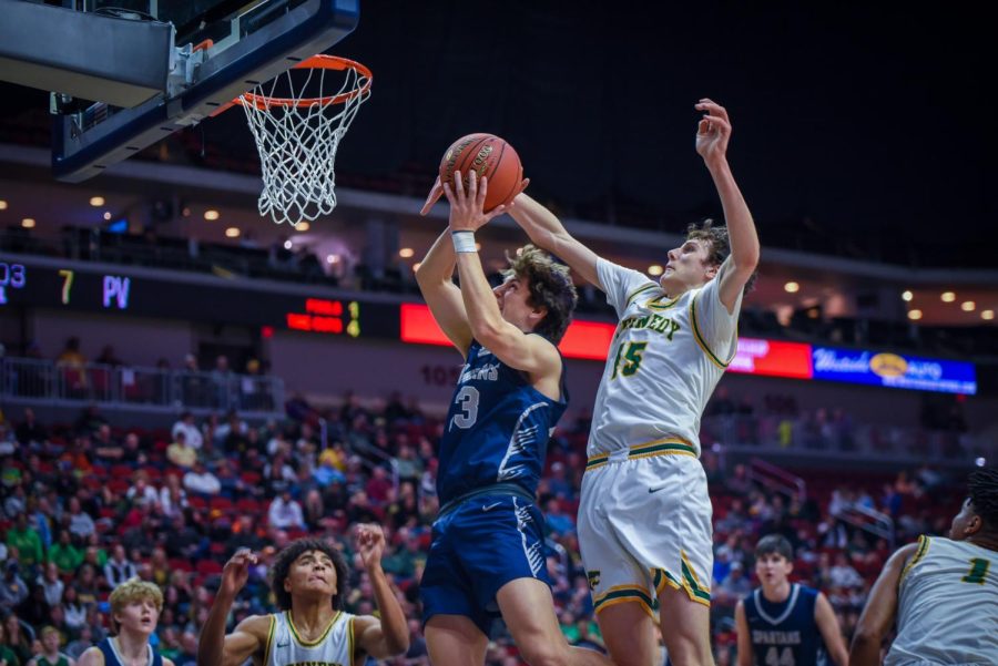 Junior Micah Schlaak reaches to block a Pleasant Valley basket.