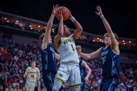 Senior Kenzie Reed looks to pass the ball to a teammate while being defended.