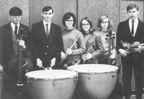 Former Kennedy Orchestral members pose for a photo.
