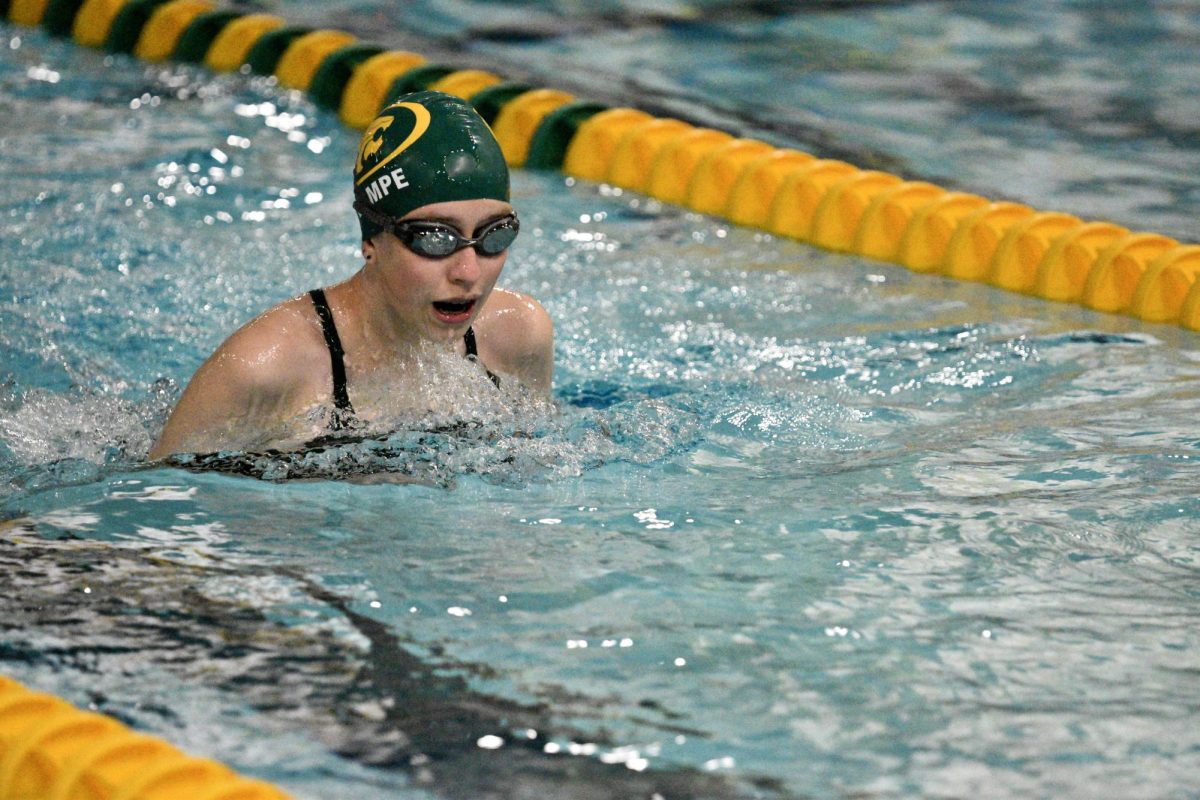 Closing the breaststroke event, junior Kira Lampe approaches the wall.