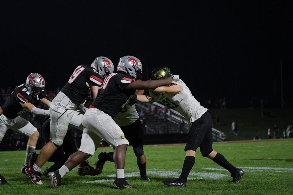 Attempting to get past the block, senior Owen Anderson fights to get to the ball carrier.