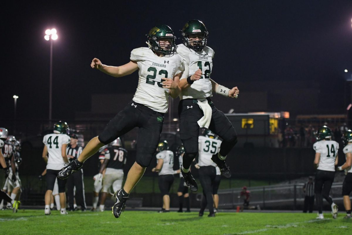 After scoring a touchdown, Junior Jacob Doyle and Vincenzo Gianforte celebrate with a mid-air shoulder bump. 