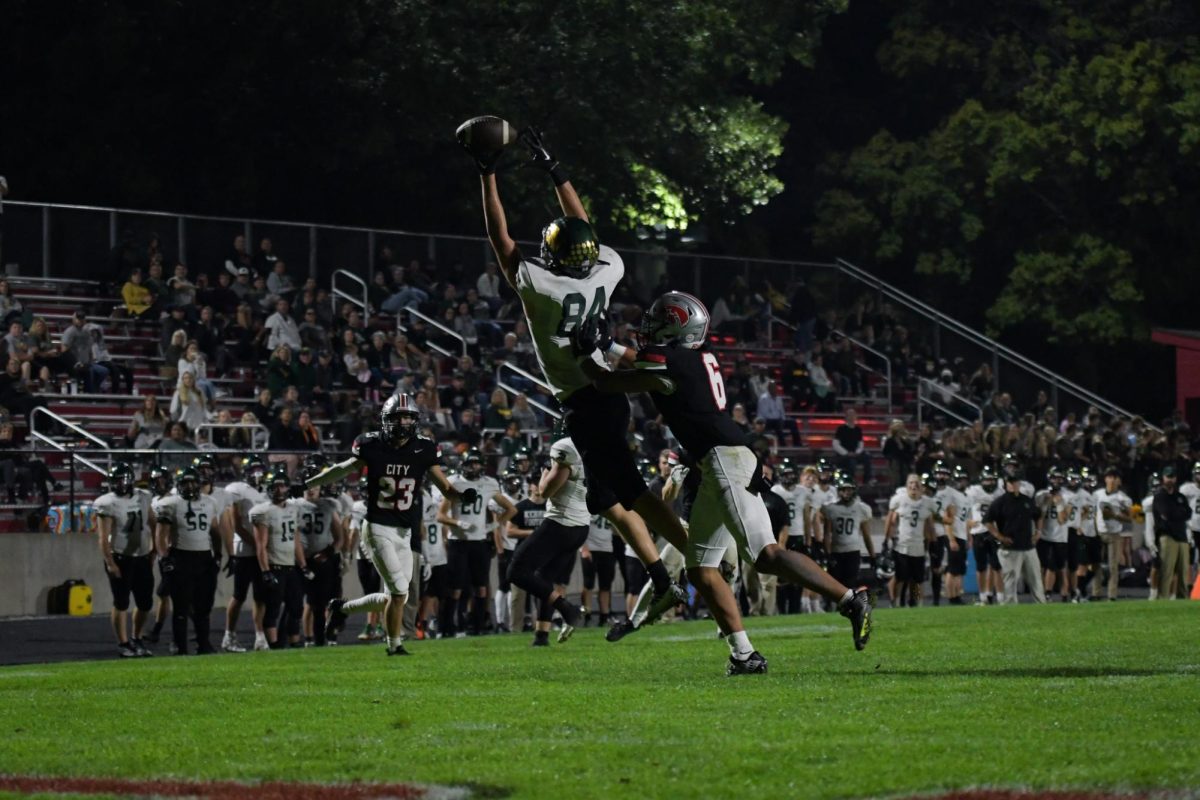 Leaping for the catch, senior Grant Mather triumphs over the defender.