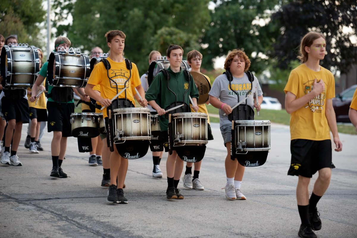 Drumline+leads+the+Kennedy+Marching+Band%2C+following+closely+behind+the+drum+majors.
