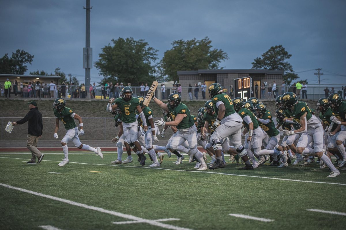 Kennedy Football Team rushes the field before Friday nights game against Washington.