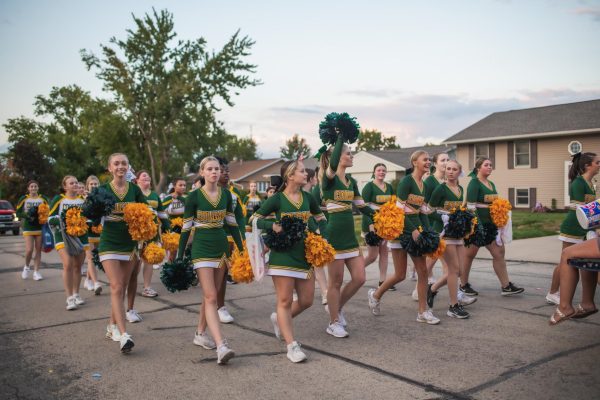 Kennedy Varsity Cheer Squad hypes up the crowd throughout the parade.