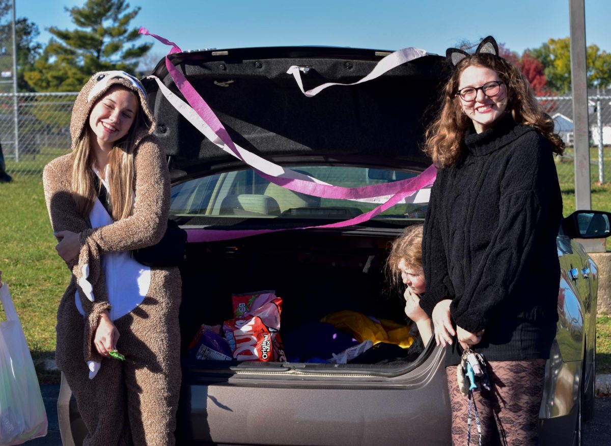 Emma+Clabaugh+and+Kenna+Mchenry+wait+for+more+people+to+come+to+their+trunk.