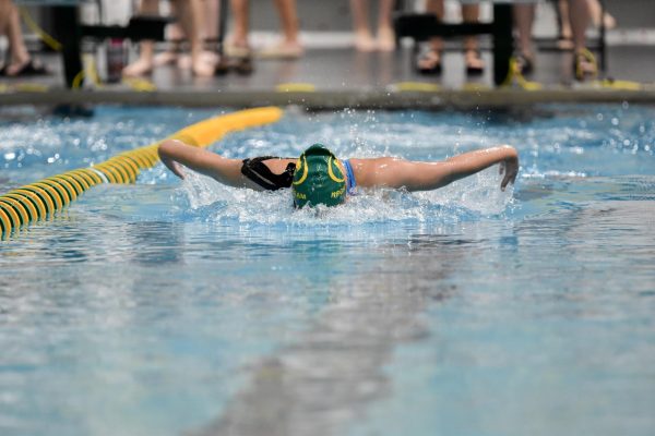 Swimming the butterfly, Lilly Adams takes first in her race 