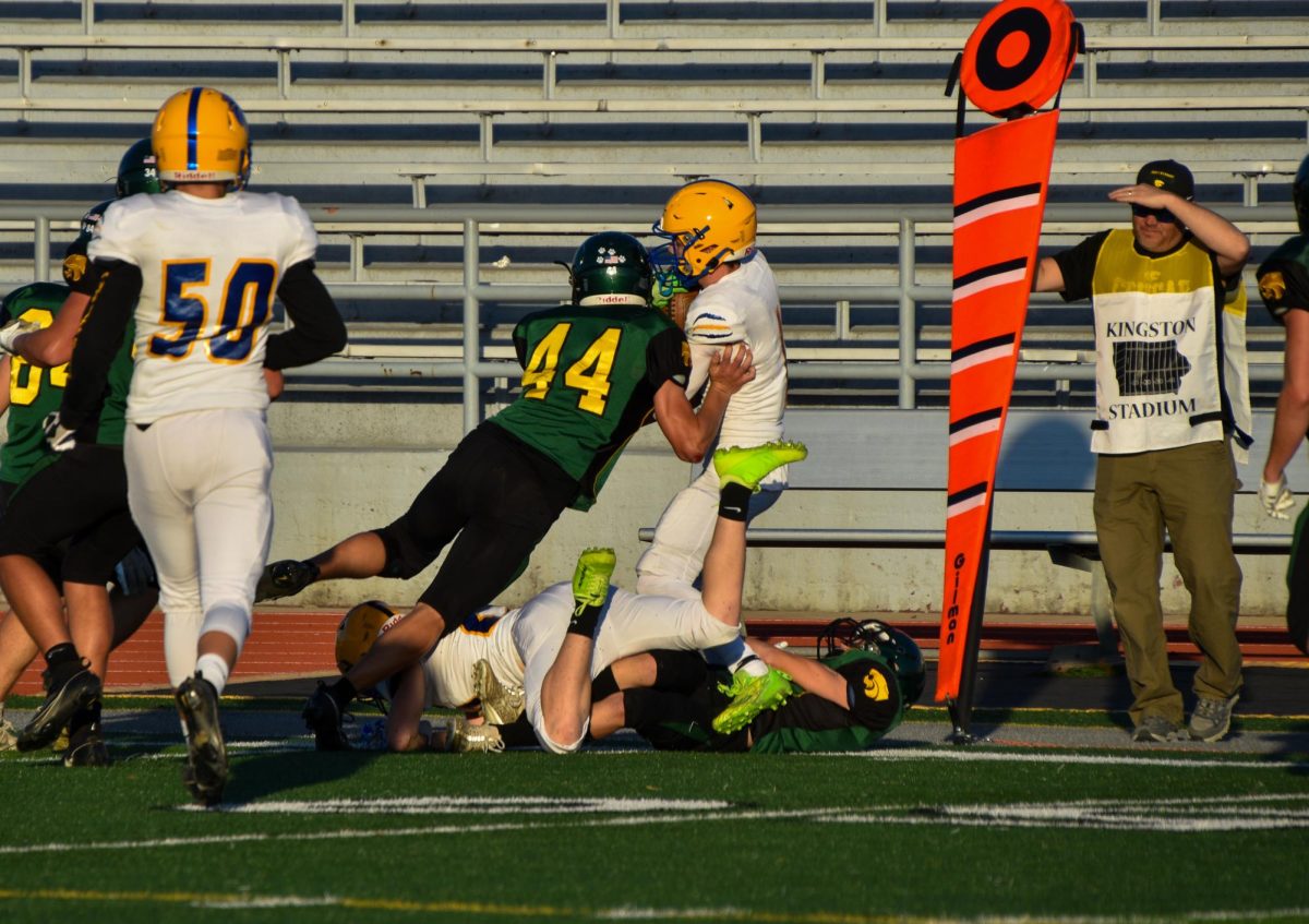 Tackling a Davenport North player, Henry Wilkes nears the 50 yard line.