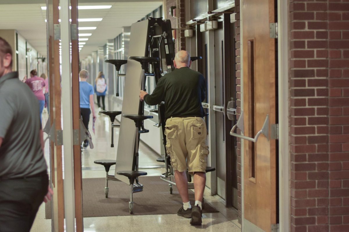 Engineers and custodians prep the hallways before the lunch period.