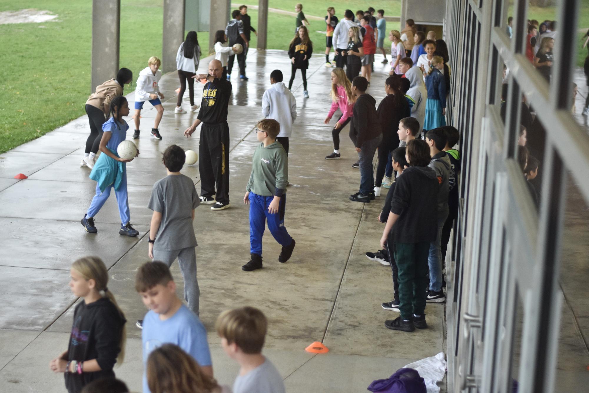 Students milling around as Taft gym classes held on the back patio.