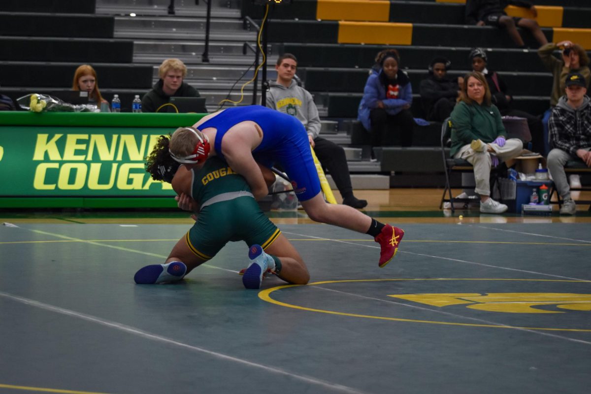 Flipping the script of the dual, a Kennedy Wrestler finds an advantage, Picking up his opponent.